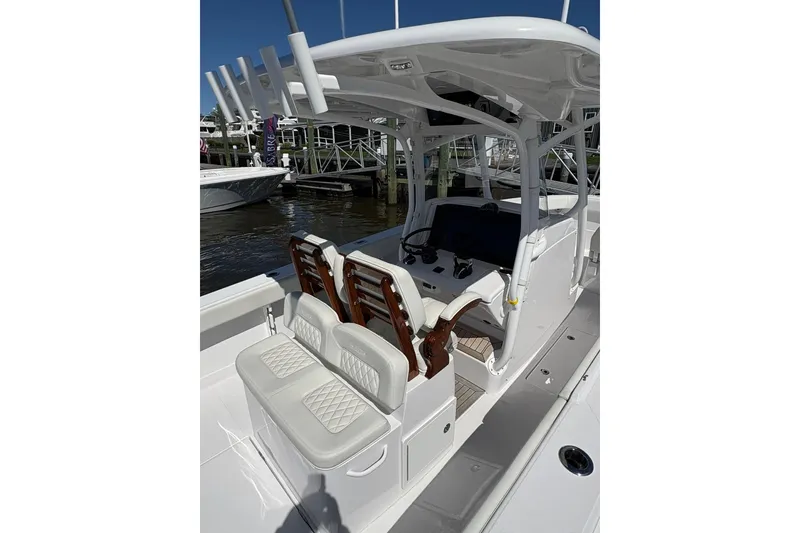 Slide: The Image of 2023 Jupiter 30 boat docked in a marina with other vessels. - 84