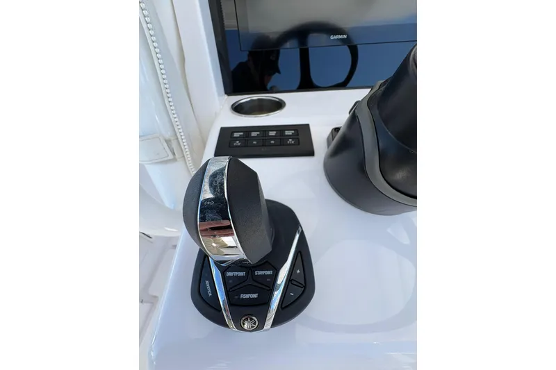 Slide: The Image of 2023 Jupiter 30 boat with dual engines navigating a marina. - 86
