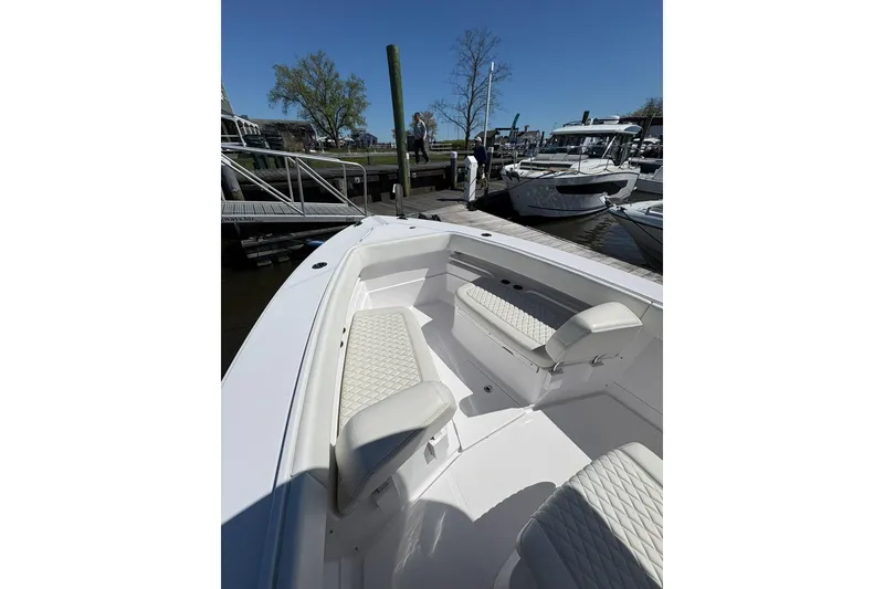 Slide: The Image of 2023 Jupiter 30 boat docked in marina with other vessels. - 88
