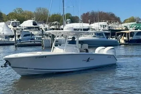 Slide: The Image of 2023 Jupiter 30 boat navigating marina, surrounded by docked vessels. - 90