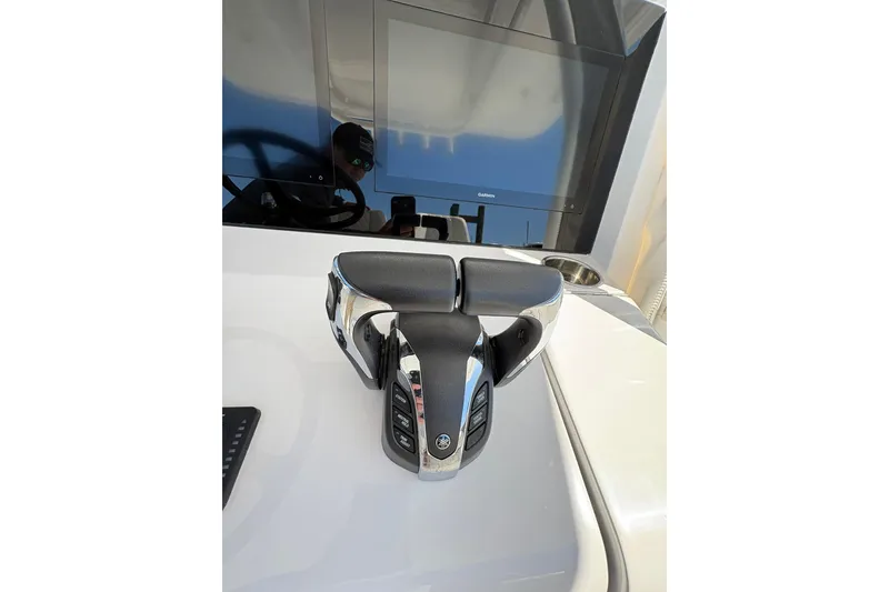 Slide: The Image of A 2023 Jupiter 30 boat cruising in a marina with other boats docked nearby. - 94