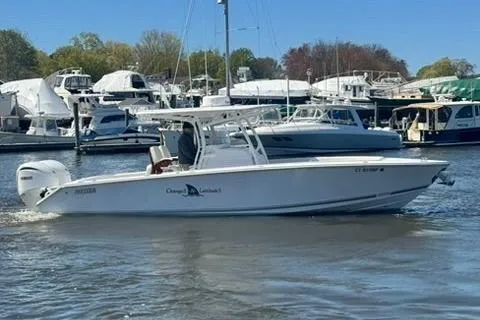 Slide: The Image of 2023 Jupiter 30 boat cruising in a marina with other vessels. - 95