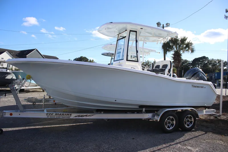 The Image of 2026 Tidewater 220 CC Adventure boat on trailer, sunny day, palm tree background. - 1