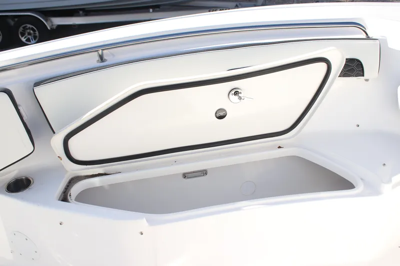Slide: The Image of 2026 Tidewater 220 CC Adventure boat storage compartment open, showcasing interior space. - 11