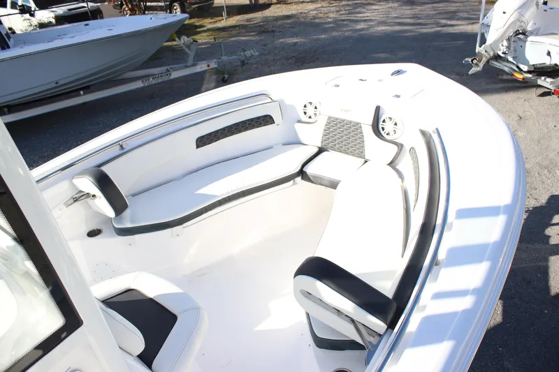 Slide: The Image of 2026 Tidewater 220 CC Adventure boat interior with cushioned seating and modern design. - 12