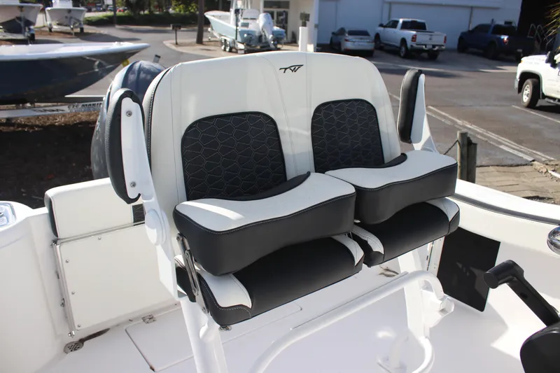 Slide: The Image of 2026 Tidewater 220 CC Adventure boat seating with black and white cushioned design. - 2