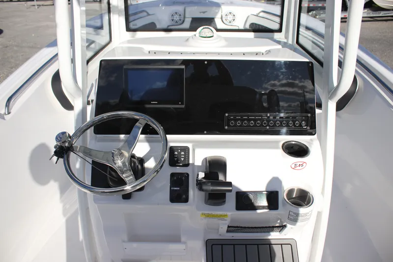 Slide: The Image of 2026 Tidewater 220 CC Adventure boat console with steering wheel and control panel. - 5