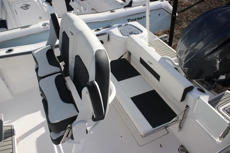 Slide: The Image of 2026 Tidewater 220 CC Adventure boat interior with seating and motor detail. - 6