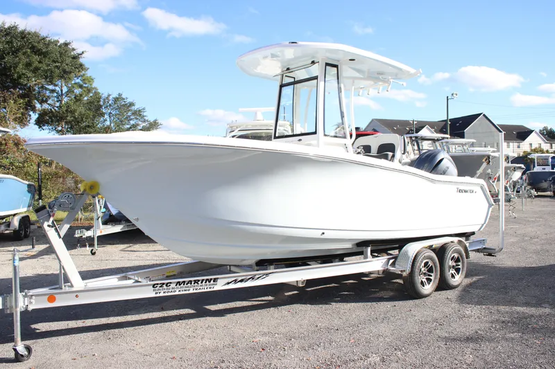 Slide: The Image of 2026 Tidewater 220 CC Adventure boat on trailer, parked outdoors under clear sky. - 7