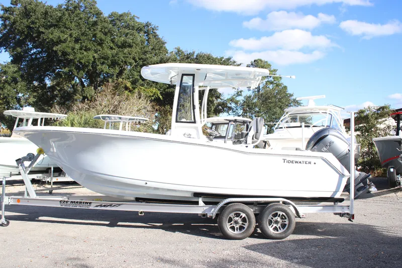 Slide: The Image of 2026 Tidewater 220 CC Adventure boat on trailer under clear sky. - 8