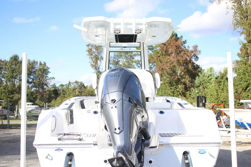 Slide: The Image of 2026 Tidewater 220 CC Adventure boat with powerful outboard motor, parked outdoors. - 9