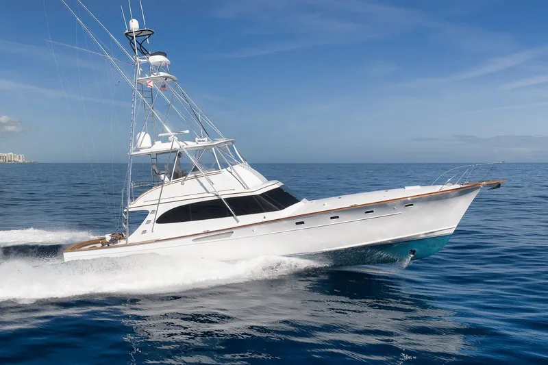 The Image of 1998 Rybovich Convertible yacht cruising on open ocean under clear blue sky. - 0