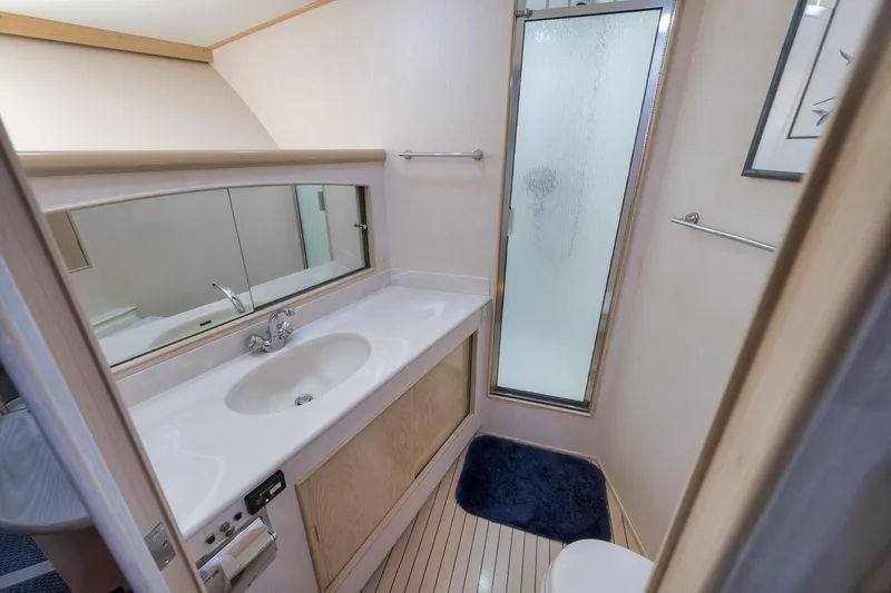 Slide: The Image of Luxurious bathroom in a 1998 Rybovich Convertible yacht with modern amenities. - 11