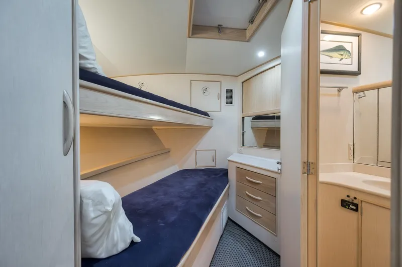 Slide: The Image of 1998 Rybovich Convertible yacht interior with bunk beds and compact bathroom. - 12