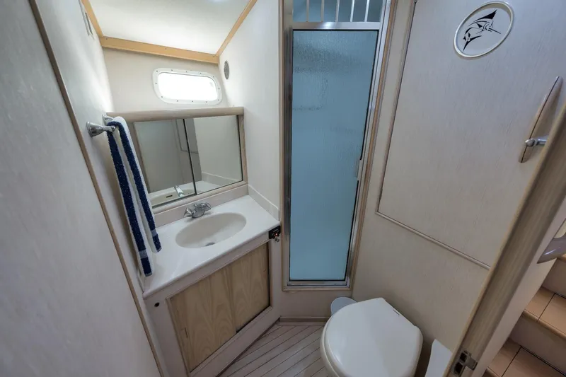 Slide: The Image of 1998 Rybovich Convertible yacht bathroom with sink, shower, and toilet. - 15