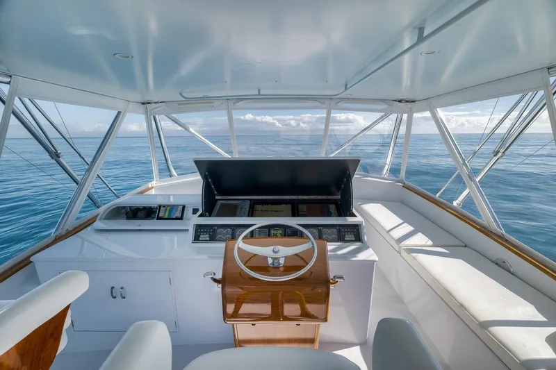 Slide: The Image of 1998 Rybovich Convertible yacht helm with ocean view, featuring sleek design and modern controls. - 16