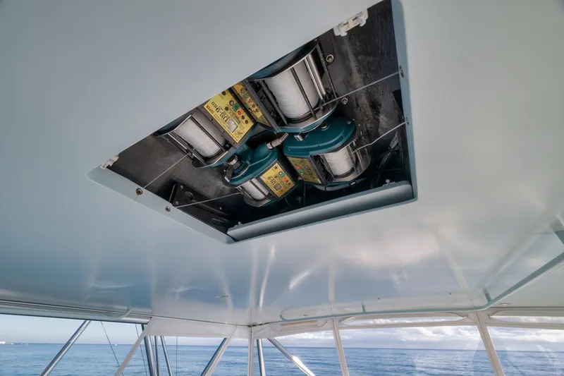 Slide: The Image of 1998 Rybovich Convertible boat interior with fishing reel setup, ocean view. - 20