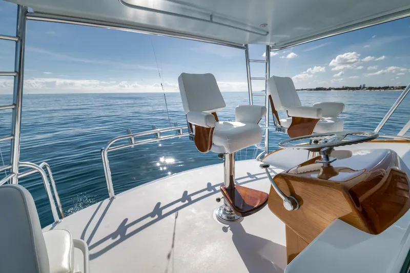 Slide: The Image of 1998 Rybovich Convertible yacht deck with ocean view and captain's chairs. - 21