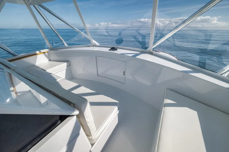 Slide: The Image of 1998 Rybovich Convertible boat interior with white seating and ocean view. - 24