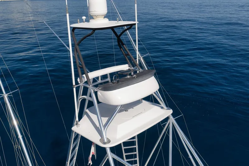 Slide: The Image of 1998 Rybovich Convertible yacht tower against a serene ocean backdrop. - 25