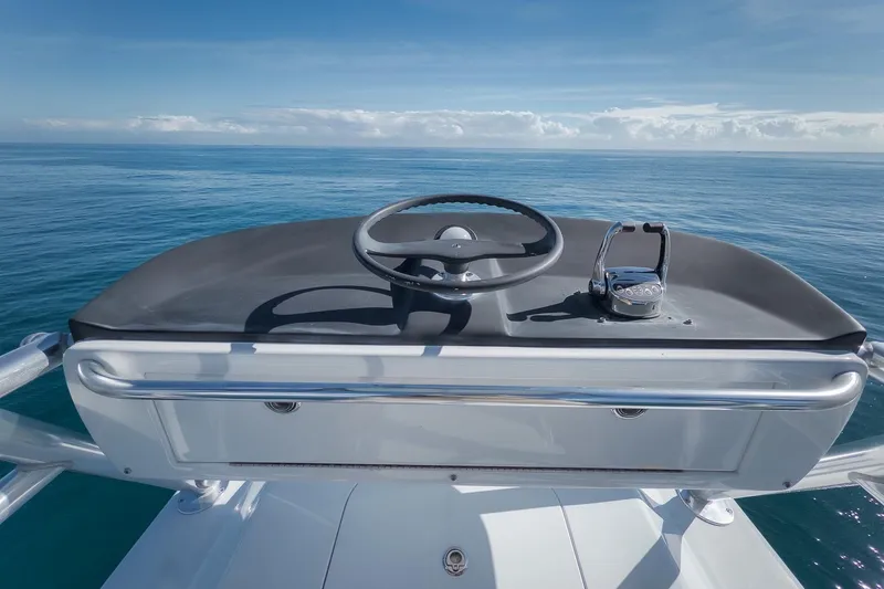 Slide: The Image of 1998 Rybovich Convertible boat helm with ocean view under clear blue sky. - 26