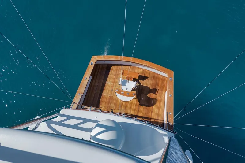 Slide: The Image of Overhead view of 1998 Rybovich Convertible yacht deck on blue ocean water. - 27