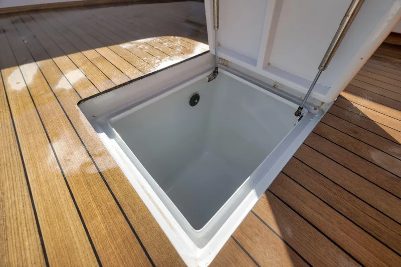 Slide: The Image of Open hatch on 1998 Rybovich Convertible boat deck, showcasing storage compartment. - 35