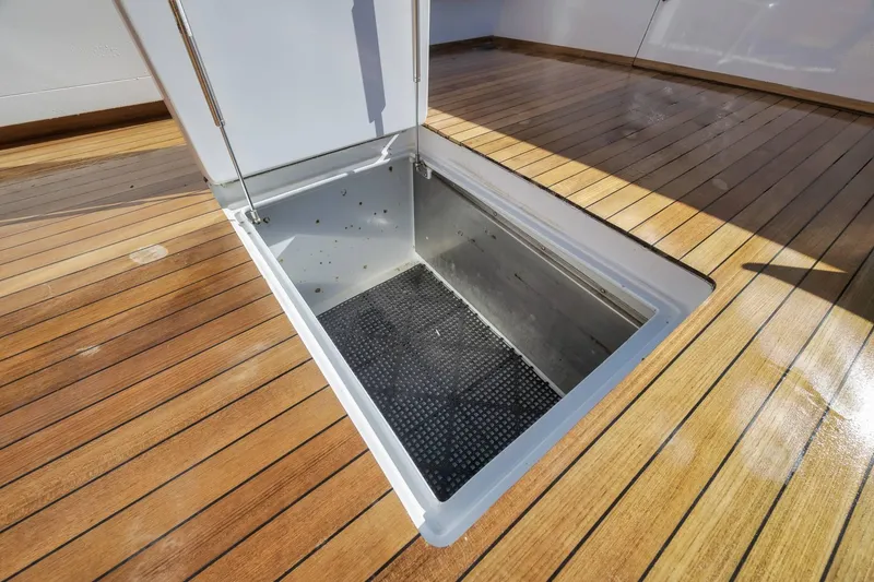 Slide: The Image of Open hatch on 1998 Rybovich Convertible boat deck, showcasing storage compartment. - 36