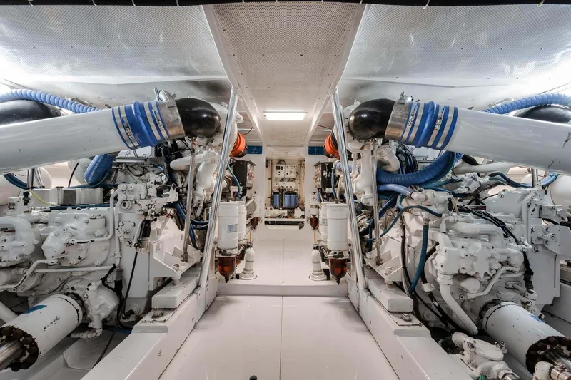 Slide: The Image of Engine room of a 1998 Rybovich Convertible boat, showcasing dual engines and mechanical systems. - 37