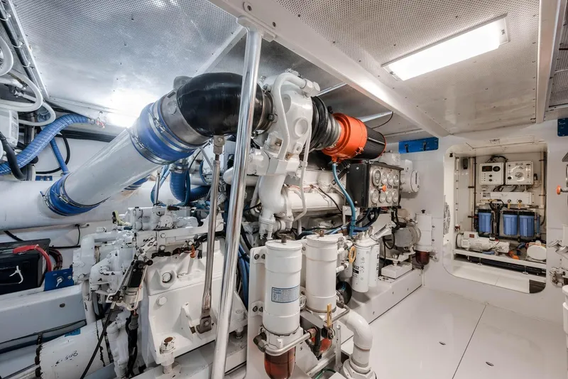 Slide: The Image of Engine room of a 1998 Rybovich Convertible yacht, showcasing complex machinery and equipment. - 39