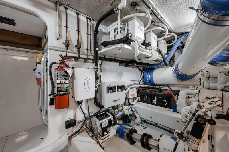 Slide: The Image of Engine room of a 1998 Rybovich Convertible boat, featuring mechanical and electrical components. - 40