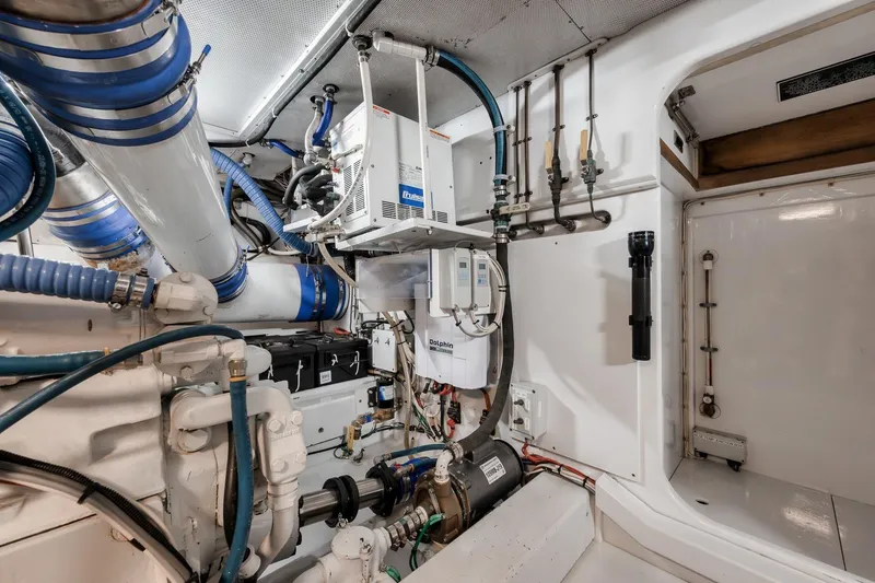 Slide: The Image of Engine room of 1998 Rybovich Convertible boat with complex piping and equipment. - 41