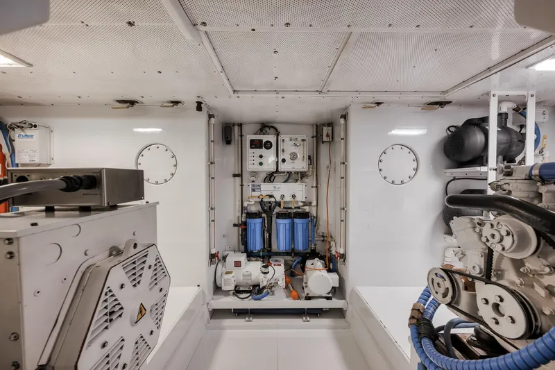 Slide: The Image of Engine room of a 1998 Rybovich Convertible yacht, featuring mechanical equipment and systems. - 42