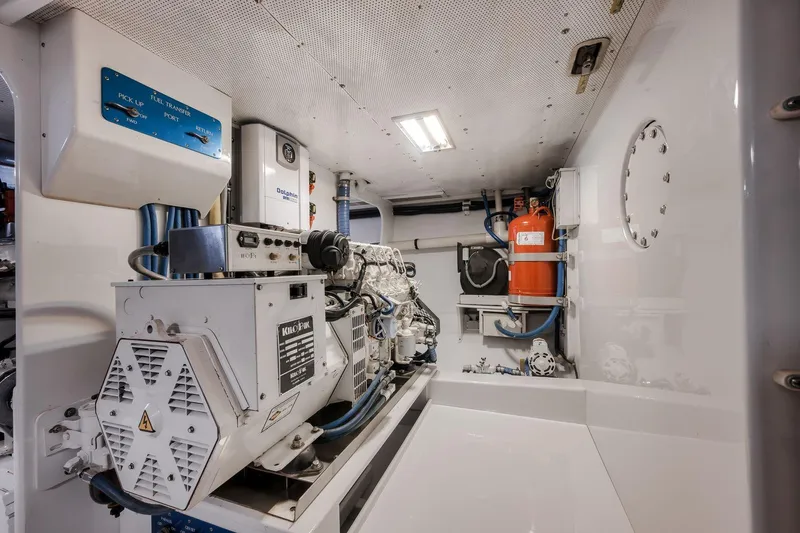 Slide: The Image of Engine room of 1998 Rybovich Convertible yacht, featuring machinery and equipment. - 43
