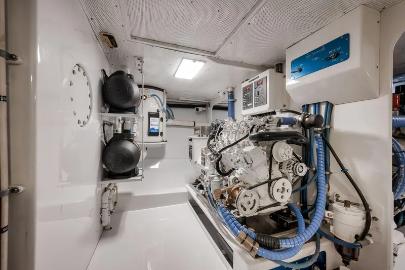 Slide: The Image of Engine room of a 1998 Rybovich Convertible boat, showcasing machinery and equipment. - 44