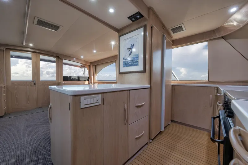 Slide: The Image of Luxurious interior of a 1998 Rybovich Convertible yacht with modern kitchen and ocean view. - 6