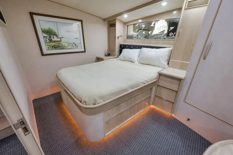Slide: The Image of Luxurious 1998 Rybovich Convertible yacht bedroom with cozy lighting and elegant decor. - 8