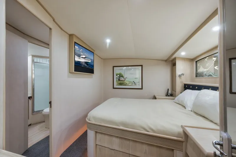 Slide: The Image of Luxurious 1998 Rybovich Convertible yacht bedroom with elegant decor and cozy bedding. - 9