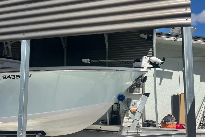 Slide: The Image of Outboard motor on a 2021 Sportsman Open 232 Center Console boat. - 21