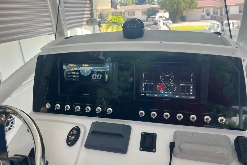 Slide: The Image of 2021 Sportsman Open 232 Center Console boat with ladder and outboard motor. - 30