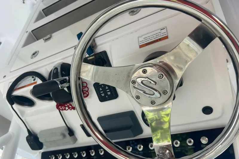 Slide: The Image of 2021 Sportsman Open 232 Center Console boat detail with trailer in sunlight. - 31