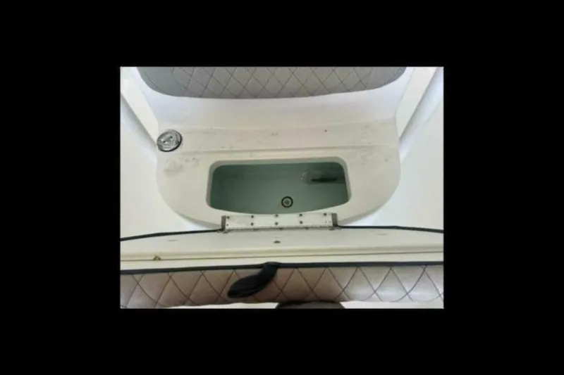 Slide: The Image of 2021 Sportsman Open 232 Center Console boat with open storage compartment and seat. - 38