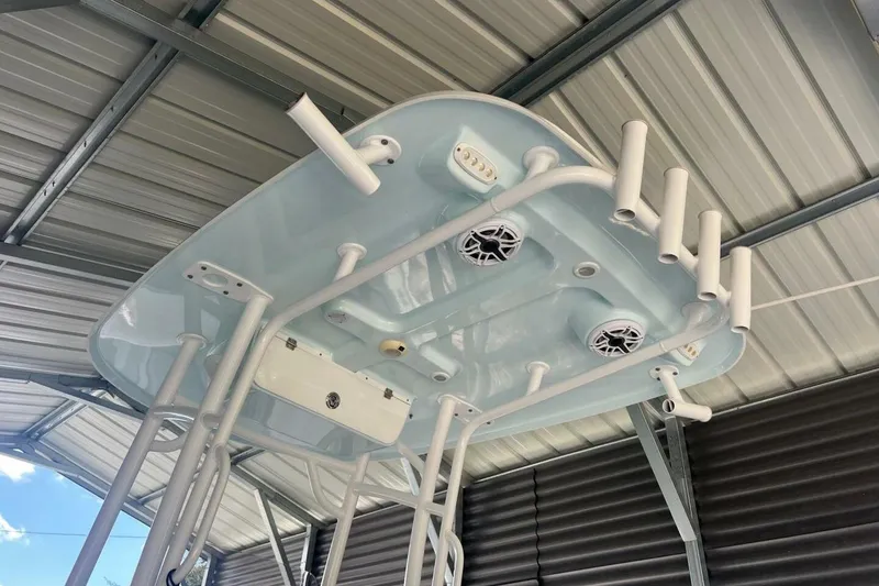 Slide: The Image of 2021 Sportsman Open 232 Center Console boat on trailer, parked beside a white truck. - 4