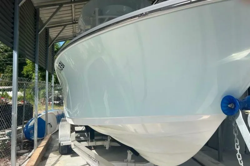 Slide: The Image of 2021 Sportsman Open 232 Center Console boat with Yamaha 250 engine in covered storage. - 44