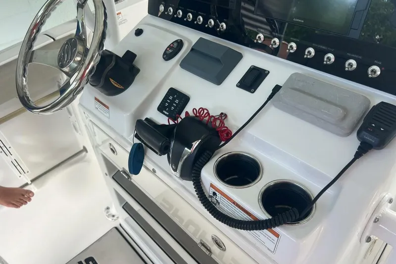 Slide: The Image of 2021 Sportsman Open 232 Center Console boat with Minn Kota trolling motor under a metal canopy. - 5