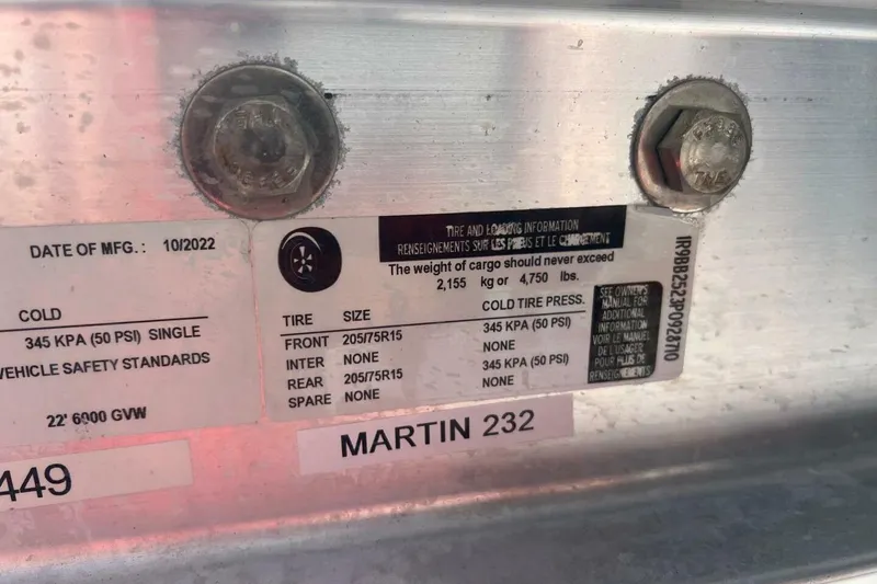 Slide: The Image of 2021 Sportsman Open 232 Center Console boat storage compartment with open hatch. - 51