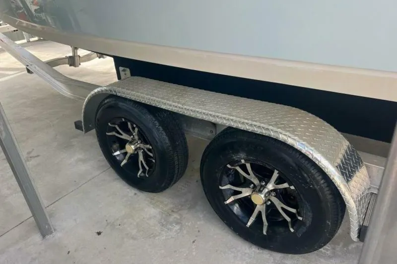 Slide: The Image of Trailer wheels of a 2021 Sportsman Open 232 Center Console boat. - 58