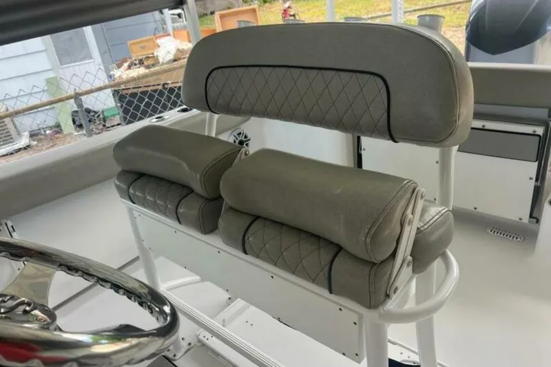 Slide: The Image of 2021 Sportsman Open 232 Center Console boat with Yamaha 250 engine in a covered storage area. - 7