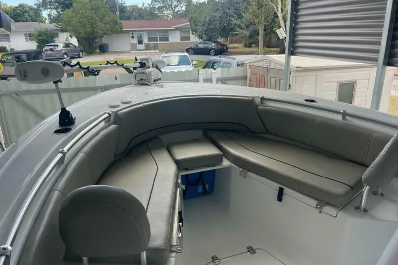 Slide: The Image of 2021 Sportsman Open 232 Center Console boat interior with seating and console under a canopy. - 8