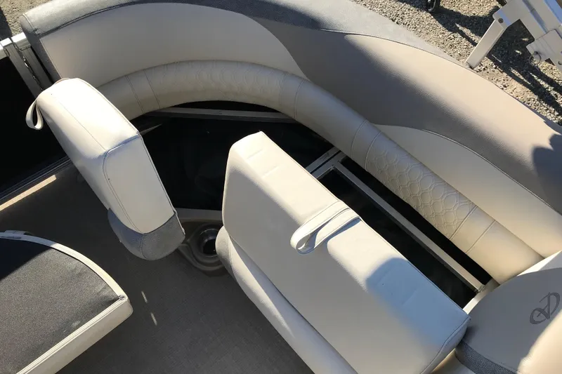 Slide: The Image of 2023 Avalon LSZ Rear Fish boat seating with storage compartment, featuring beige upholstery. - 13